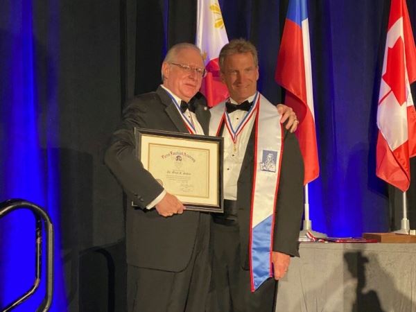 Father & son receiving an award together